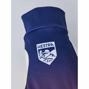 Blue Hestra glove cuff with white brand logo