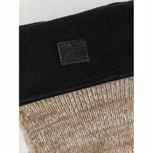 Hestra glove cuff detail with black fabric and velcro closure over beige knit material