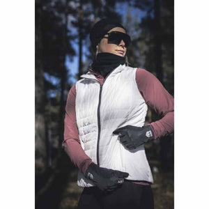 Person wearing a white Hestra vest over a maroon long sleeve shirt with black gloves and sunglasses