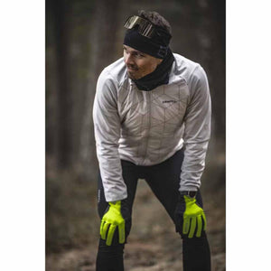 Person wearing Hestra neon yellow gloves and athletic gear outdoors