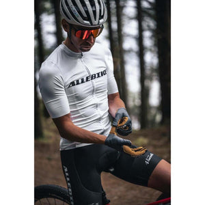 Cyclist wearing Hestra gloves and Allebike cycling gear in a forest