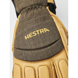Hestra tan leather glove with dark grey textured fabric panel and embroidered logo