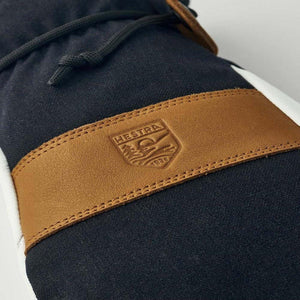 Close up of Hestra leather logo patch on black fabric glove