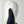 White leather mitten with black thumb panel and brown leather strap detail