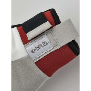Close up of a Gore-Tex Infinium label on a red white and grey glove cuff