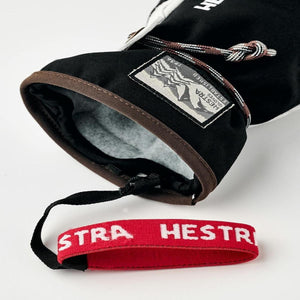 Hestra black glove cuff with interior lining and red wrist strap