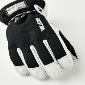 Hestra black and white ski glove with wrist drawstring and brand logo