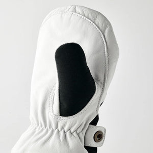 Hestra white leather mitten with black fabric insert and snap button closure