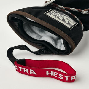 Black Hestra mitten with grey fleece lining and red wrist strap