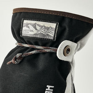 Hestra glove cuff with mountain logo patch and adjustable drawstring