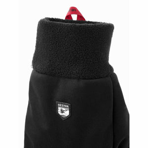 Black Hestra mitten with fleece cuff and red pull tab
