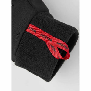 Black fleece glove cuff with red Hestra branded pull tab