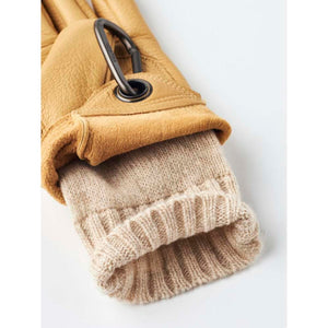 Tan Hestra leather glove with a ribbed knit cuff and carabiner attachment