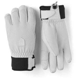 Hestra white and black ski gloves with wrist straps and logo patch