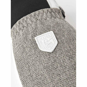 Hestra logo patch on grey textured glove fabric