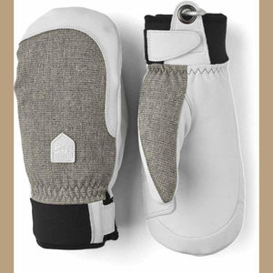 Hestra white and grey leather mittens with black cuffs and wrist straps