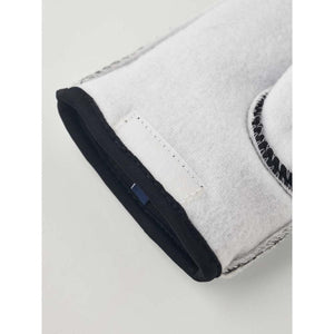Close up of white Hestra glove cuff with black trim