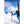 Skier wearing Hestra gloves hiking uphill with skis on backpack
