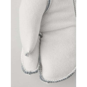 Close up of white Hestra wool mitten showing textured fabric and grey stitched seams