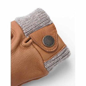 Hestra tan leather glove cuff with grey knit trim and branded metal snap button