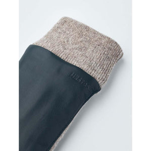Hestra glove with dark leather palm and beige wool cuff