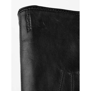 Close up of black leather Hestra glove cuff with embossed logo
