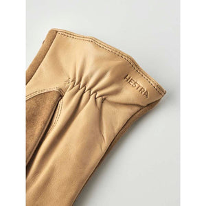 Tan leather Hestra glove cuff with gathered detail and embossed logo