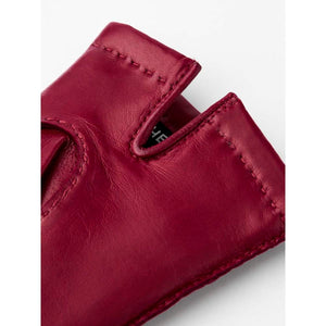 Close up of red leather glove cuff with visible stitching