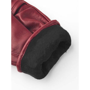 Close up of Hestra red leather glove cuff with black fleece lining