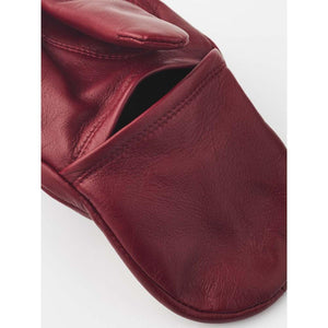 Close up of red Hestra leather mitten detail