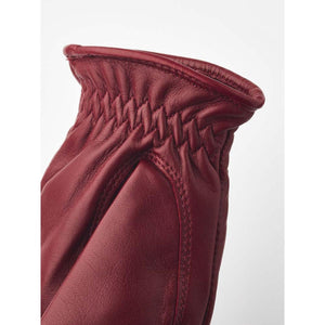Hestra burgundy leather glove cuff with gathered elastic detail