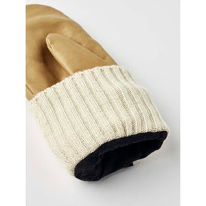 Hestra tan leather mitten with a ribbed cream knit cuff and black interior lining