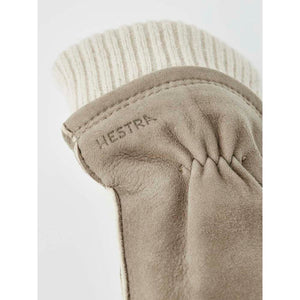 Close up of beige Hestra suede glove with ribbed knit cuff