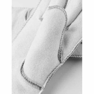 Close up of light grey suede sheepskin gloves with visible stitching