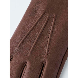 Brown Hestra leather glove with decorative stitching on the back