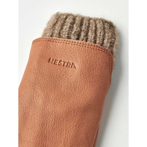 Hestra tan leather mitten with a brown ribbed wool cuff