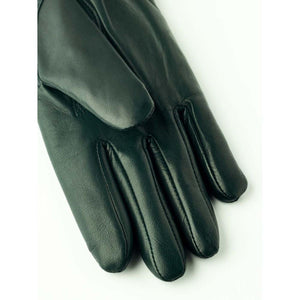 Dark green leather glove on white background