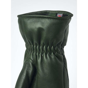 Close up of dark green leather glove cuff with gathered elastic wrist detail