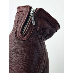 Close up of a dark brown Hestra leather glove cuff with a metal zipper