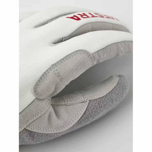 Close up of Hestra white and grey leather glove with red logo