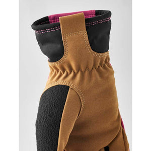 Hestra glove cuff detail showing brown suede and black fabric with pink stitching