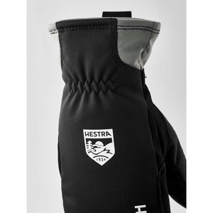 Black Hestra glove with grey cuff detail and white brand logo
