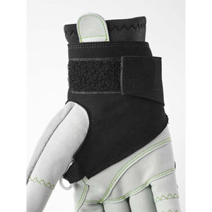 Close up of a grey work glove with a black adjustable velcro wrist strap