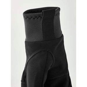 Close up of black glove cuff with elasticated trim and pull tab