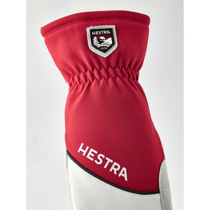 Red Hestra glove with white Hestra logo and brand patch