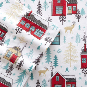 Shavel flannel sheet pattern with red houses, deer, and pine trees on white background