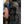 Hillsound trekking poles secured to the side of a hiking backpack