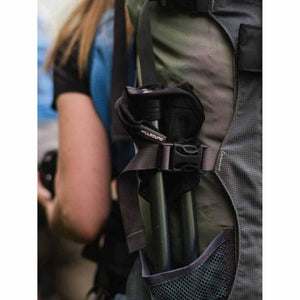 Hillsound trekking poles secured to the side of a hiking backpack