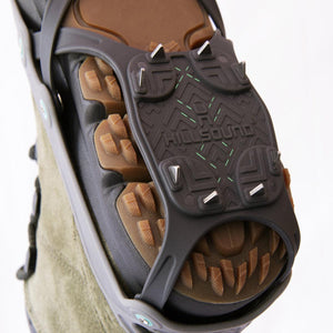 Hillsound traction spikes attached to the sole of a hiking boot