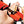 Hand using an allen key to adjust a red and black crampon